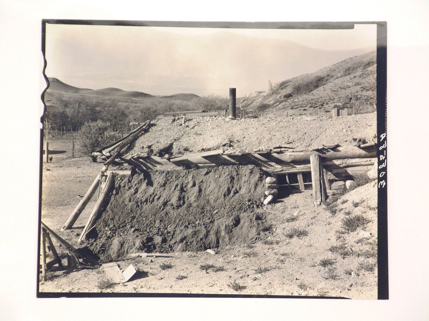 View of home built into side of hill, constructed of earth