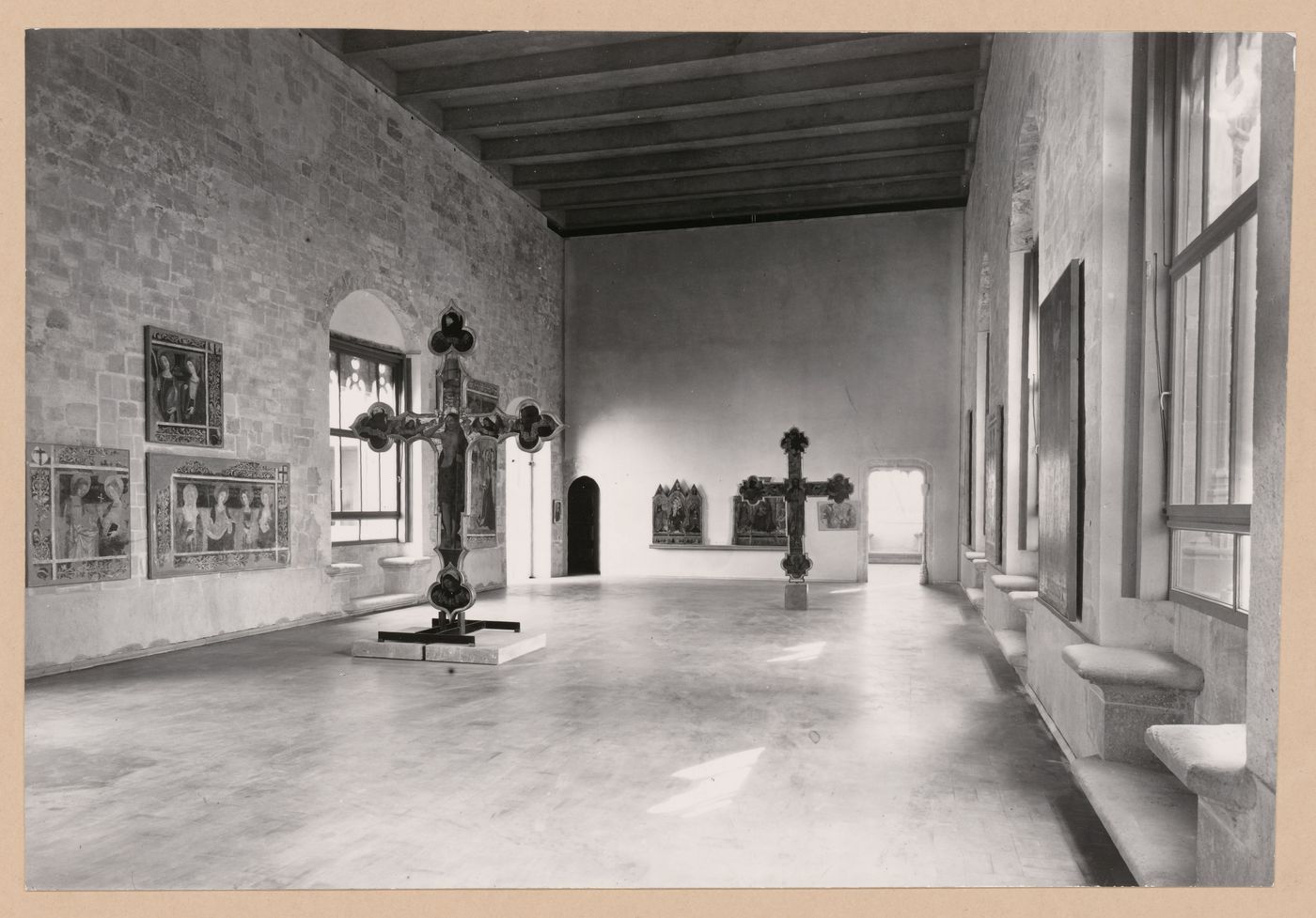 Interior view of Il Salone showing two freestanding painted crucifixs and paintings, Palazzo Abatellis, Galleria regionale della Sicilia, Palermo, Italy