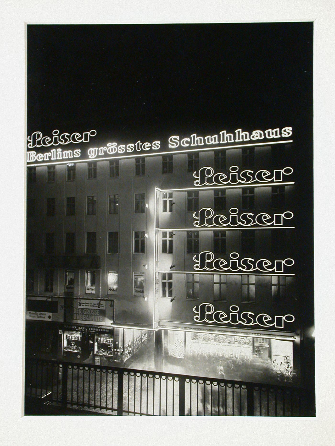 Night view of Leiser shoe store and its advertising signs, Berlin, Germany