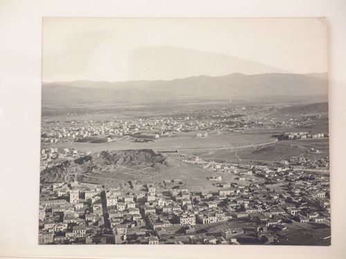 Aerial view of an unidentified city with mountains in the background