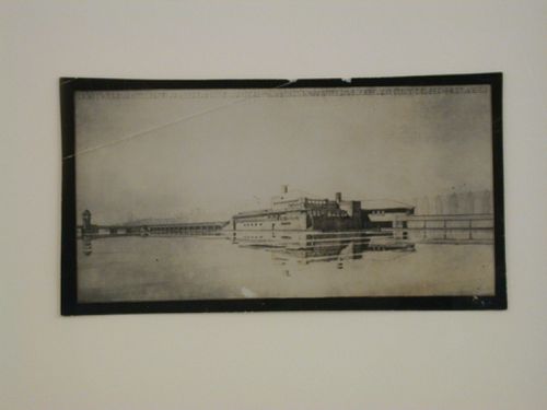 Photograph of a rendering for the Berlagebrug-complex showing the Amstelbrug [Amstel Bridge] (also known as the Berlagebrug) and Amstelpaviljoen [Amstel Pavilion] from across the Amstel River, Amsteldijk [Street], Amsterdam, Netherlands