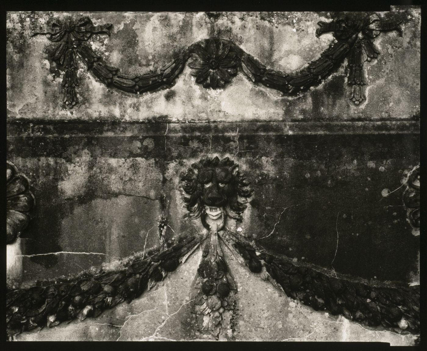 Relief design of floral patterns and lion head on stone wall, County Mayo, Ireland