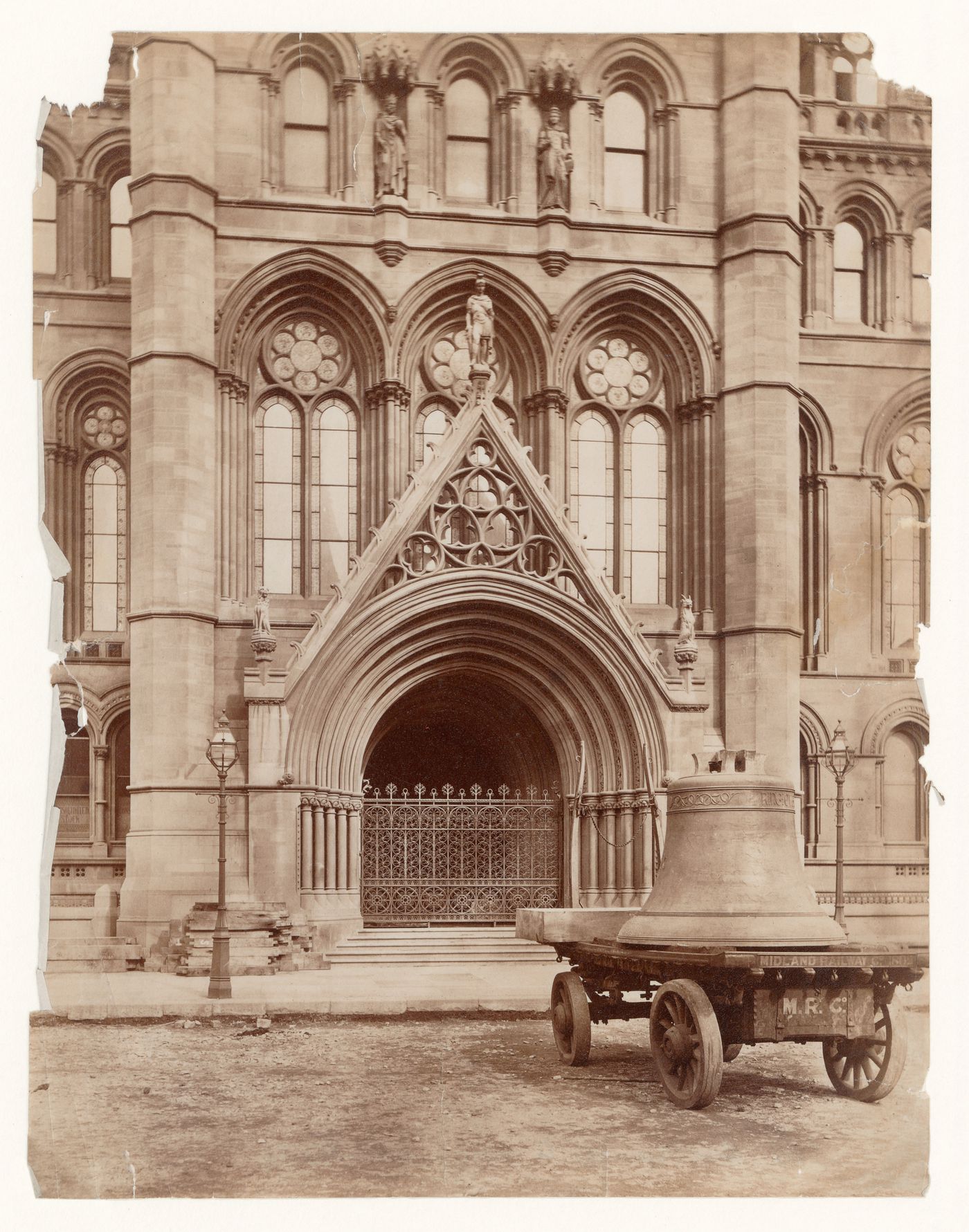Detail of entrance to the new Town Hall, showing a cart loaded with a bell in the foreground, Manchester, England