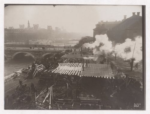 Construction of the Paris Metro, exterior view with machinery, workers and smoke coming out of smoke stacks, Paris, France