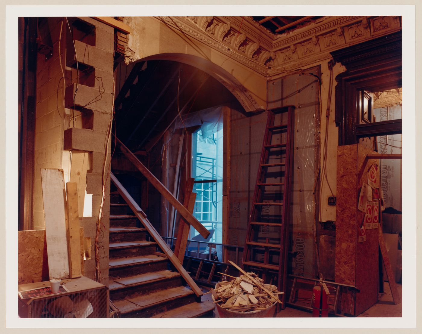 Interior view of a hall showing the original carved wooden stairs, Shaughnessy House, Montréal, Québec