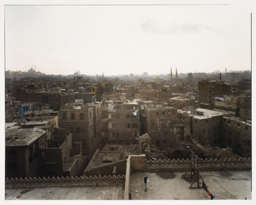 View of city from El Ashar, showing figure on roof directly below, Cairo, Egypt