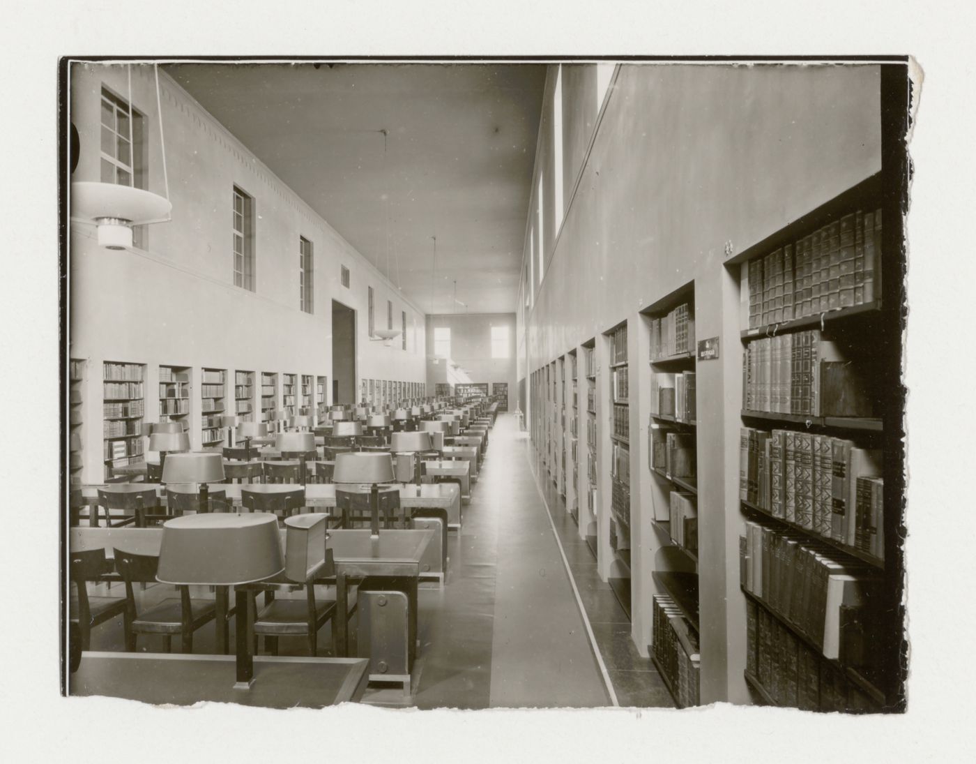 Interior view of the south reading room of Stockholm Public Library showing tables, chairs and bookshelves, 51-55 Odengatan, Stockholm
