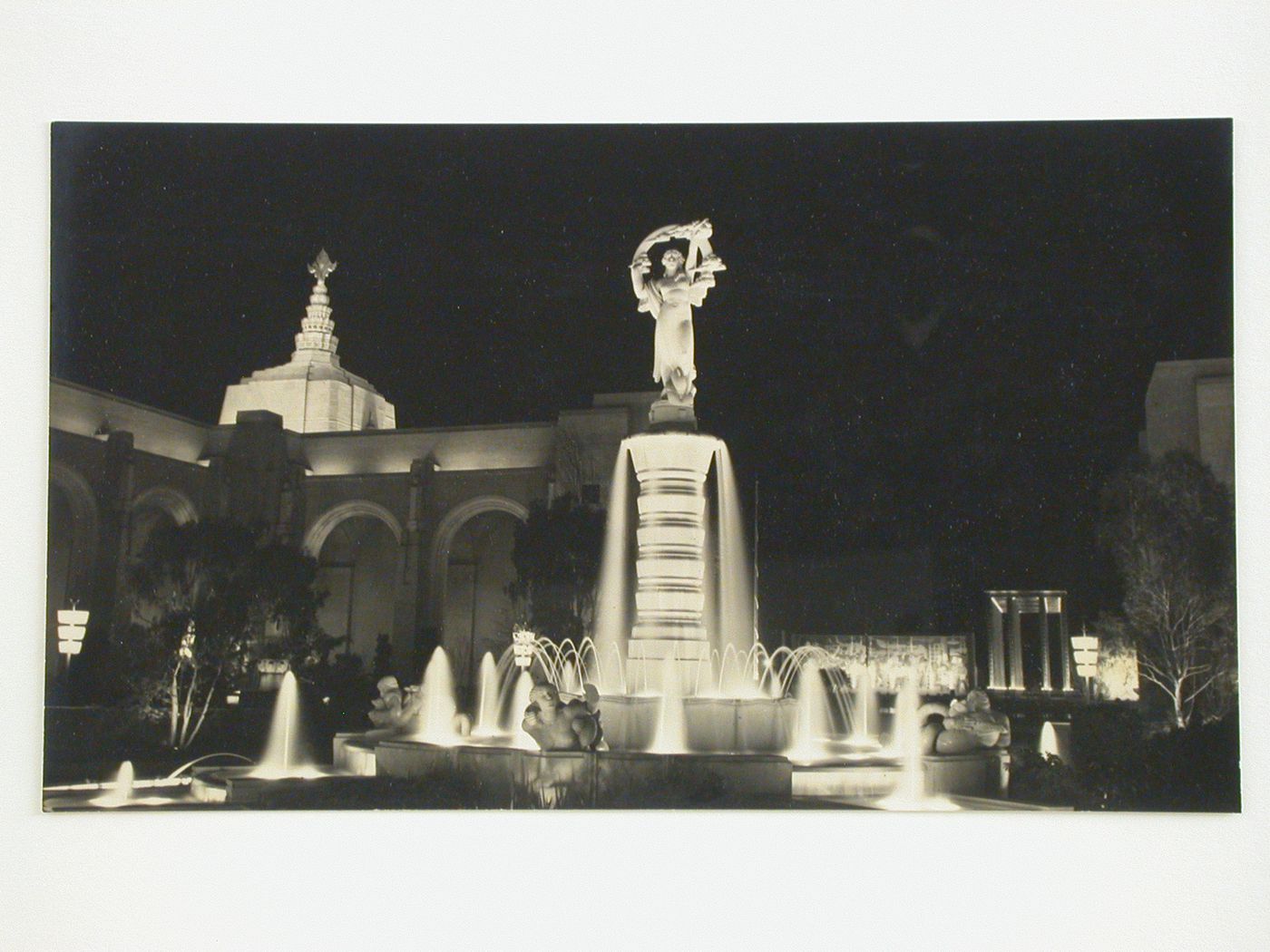 Night view of the Girl and Rainbow Fountain in the Court of Flowers looking towards the Lake of the Nations, Golden Gate International Exposition of 1939-1940, Treasure Island, San Francisco, California