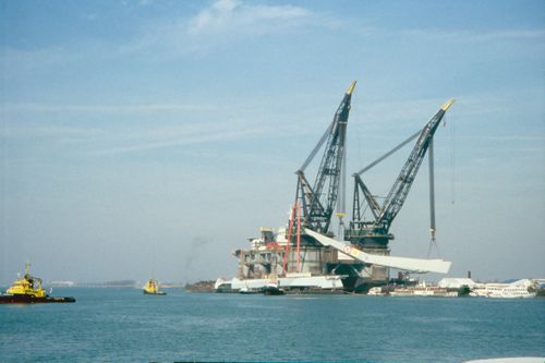 View of pylon being lifted onto heels, in preparation for final transportation to the site, Erasmus Bridge construction, Rotterdam