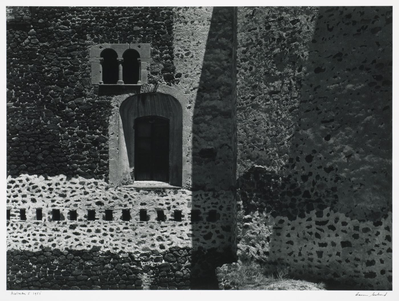 View of windows in a stone wall, possibly the Monastery of San Augustin, Alcoman, Mexico