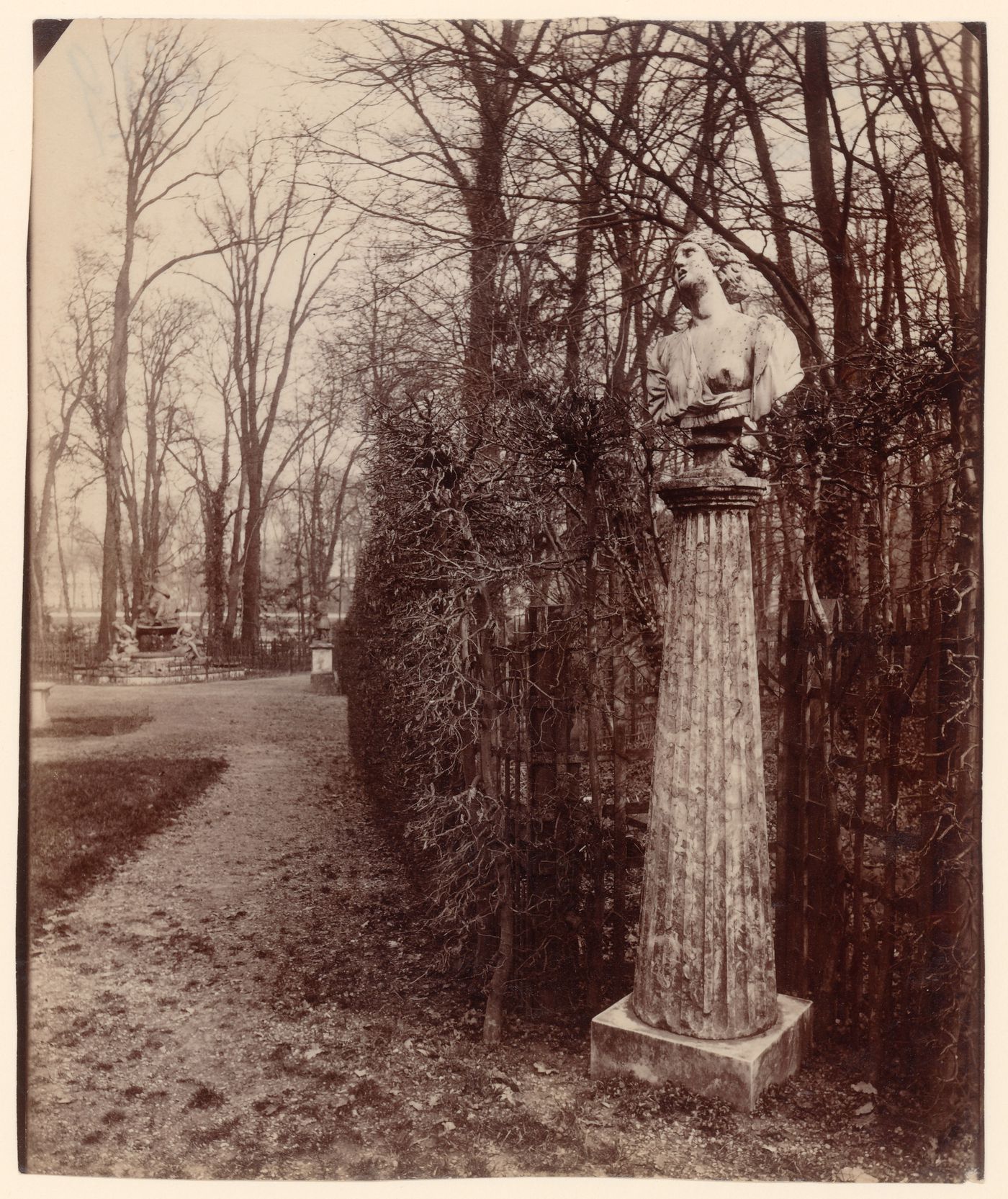 View of the arbor of the Triumphal Arch, statue on column pedestal in foreground, Versailles, France