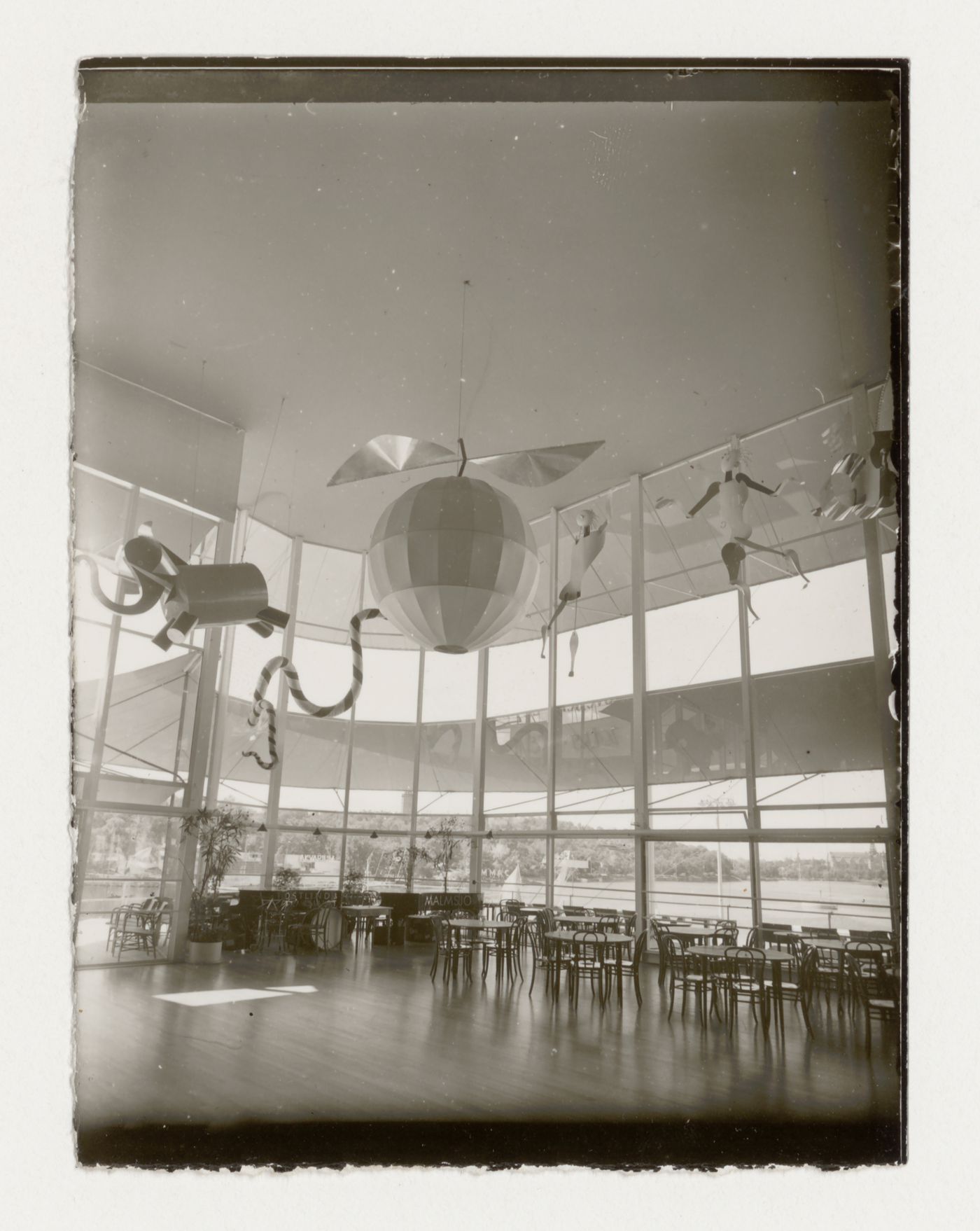 Interior view of Paradise Restaurant dance hall at the Stockholm Exhibition of 1930 showing ceiling ornaments, tables and chairs, Stockholm