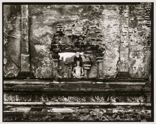 Partial view of the wall of an unidentified temple showing a statue in a niche, Sri Lanka