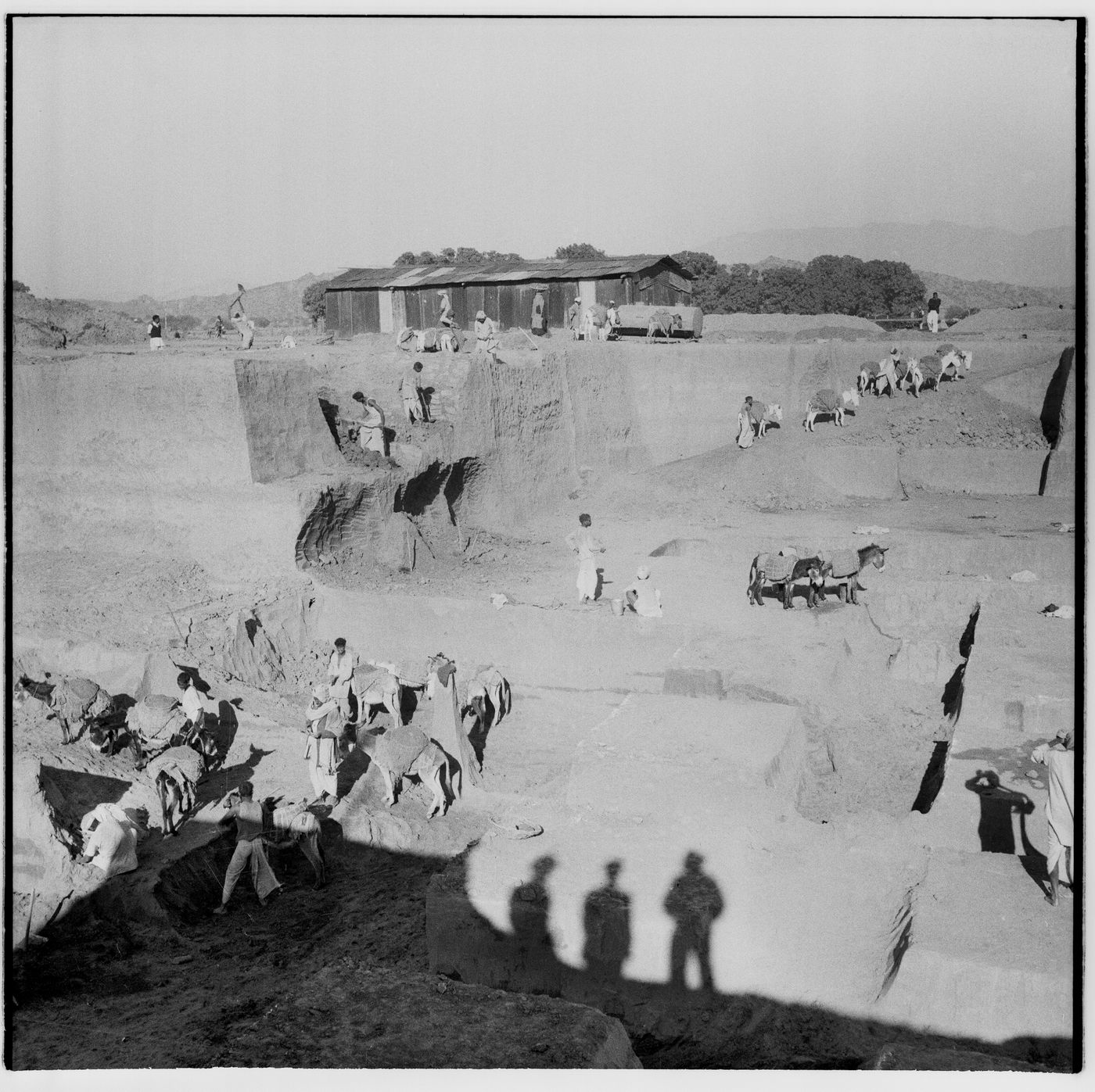 Excavation of the foundations for the High Court Building, Chandigarh, India (with shadows of Le Corbusier, Jeet Malhotra and Pierre Jeanneret in the foreground)