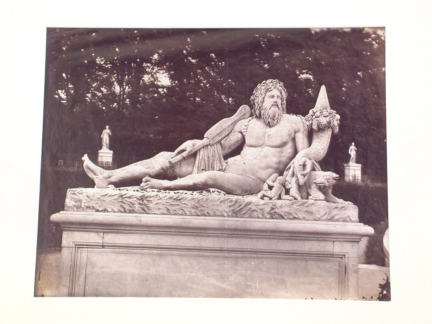 Tuileries Gardens, view of a reclining male god, carved in stone, Paris, France