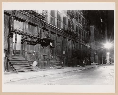 View of apartment houses at night in Soho showing fire escapes, New York City, New York