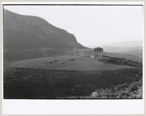 Distant view of the ruins of the Temple of Poseidon showing the countryside and a mountain, Segesta, Italy