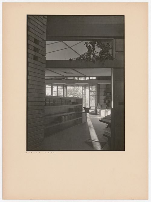 Interior view of the Hanna House showing a doorway, windows, bookshelves, tables, and seating furniture, Palo Alto, California, United States