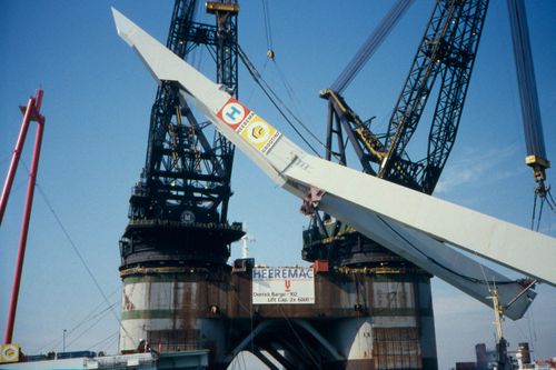 View of pylon being lifted onto heels, in preparation for final transportation to the site, Erasmus Bridge construction, Rotterdam