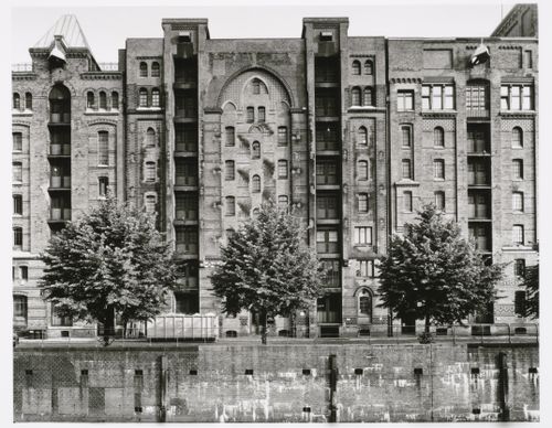 View of a Speicherblock [Storage Block] of Speicherstadt [Storage City] warehouses from across a canal, Altstadt, Hamburg, Germany