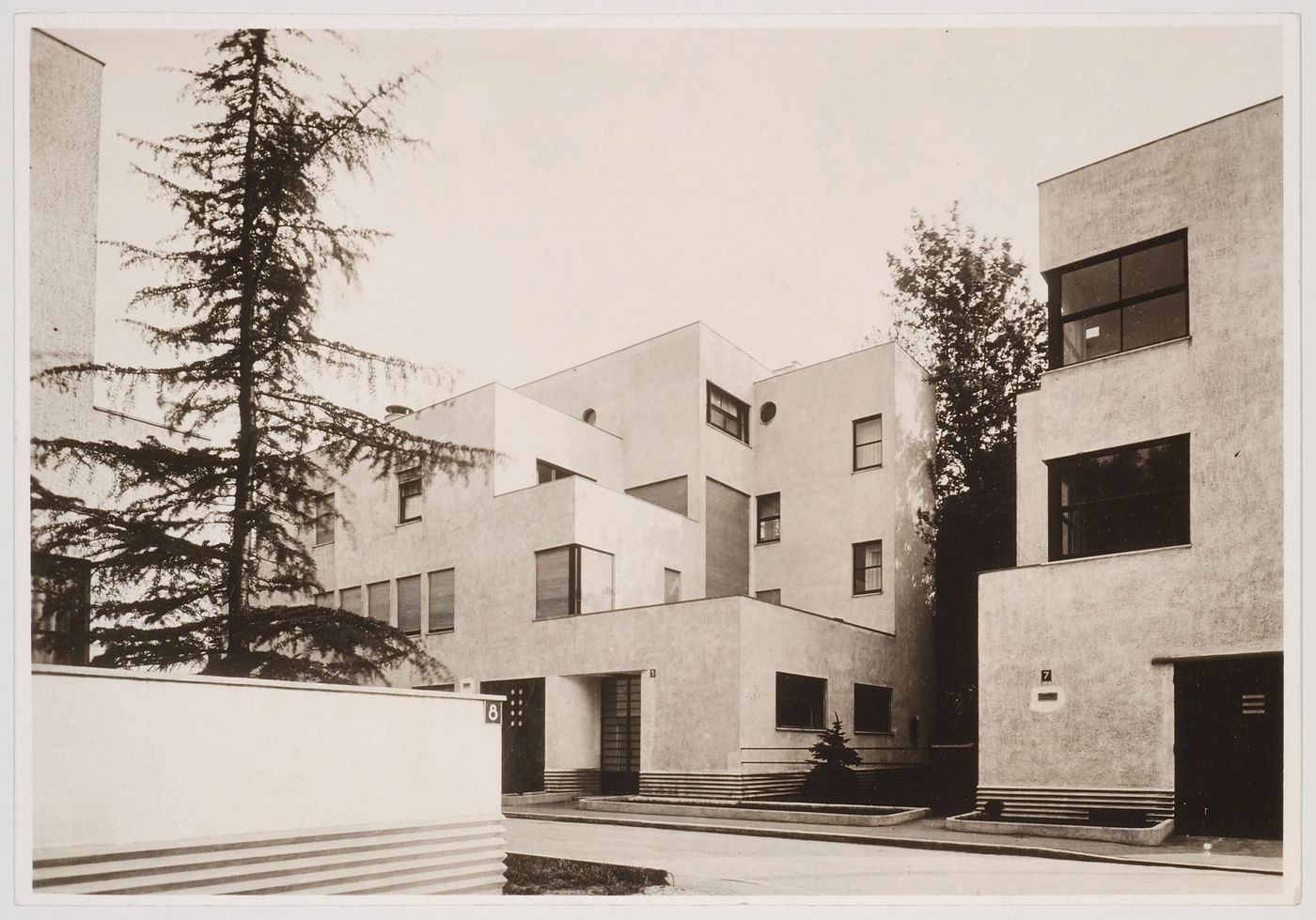 Partial views of Allatini House (no. 3-5) and Dreyfus House (no. 7) from driveway of no. 8 across the street, rue Mallet-Stevens, Auteuil district, Paris, France