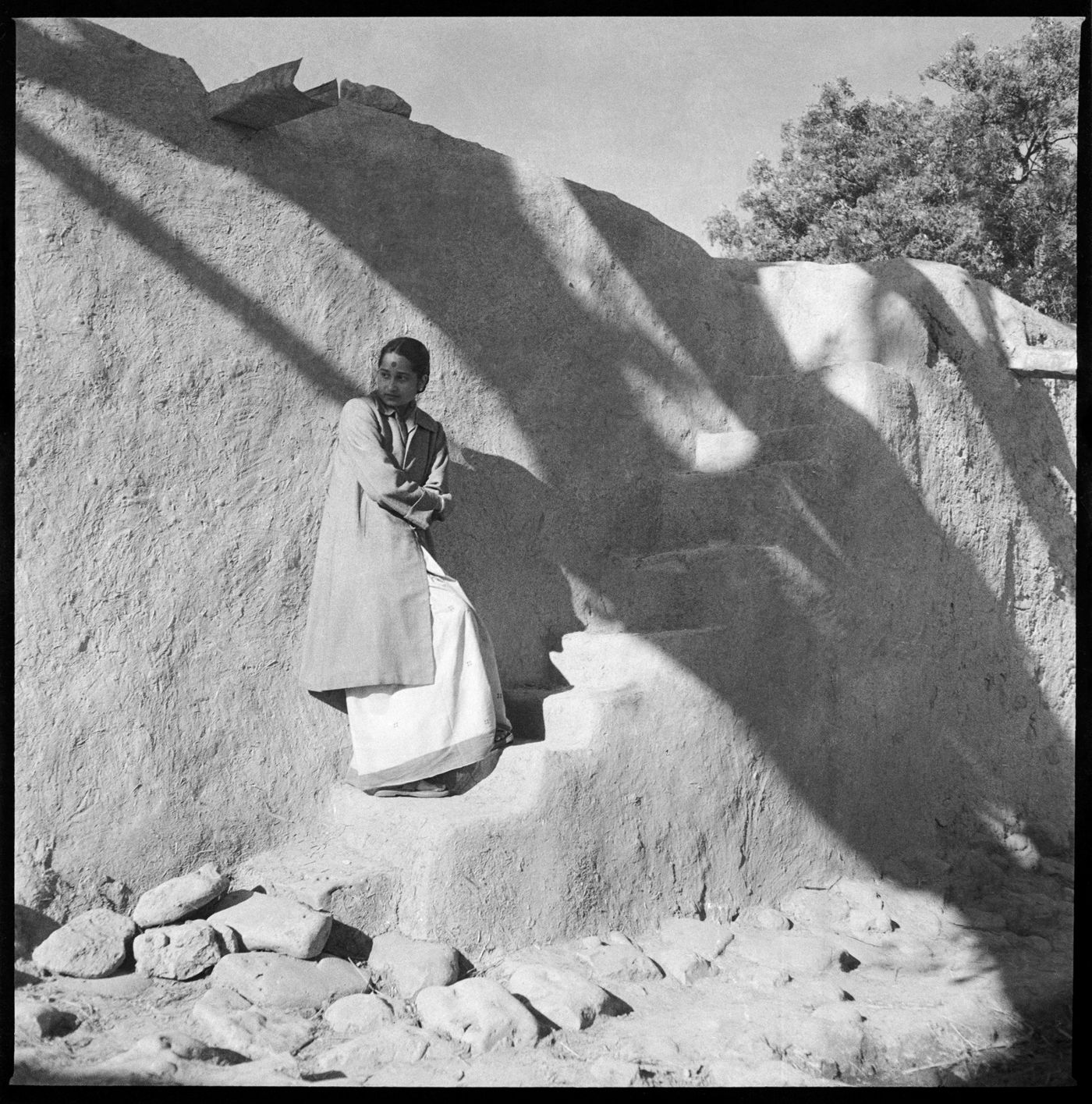 Woman standing on the stairs of a rural house in Chandigarh's area before the construction, India