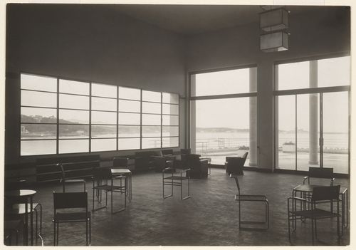 Interior view, room with scattered chairs and large windows, through which the bay is visible, Saint-Jean-de-Luz, France