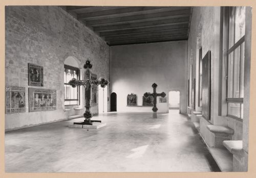 Interior view of Il Salone showing two freestanding painted crucifixs and paintings, Palazzo Abatellis, Galleria regionale della Sicilia, Palermo, Italy