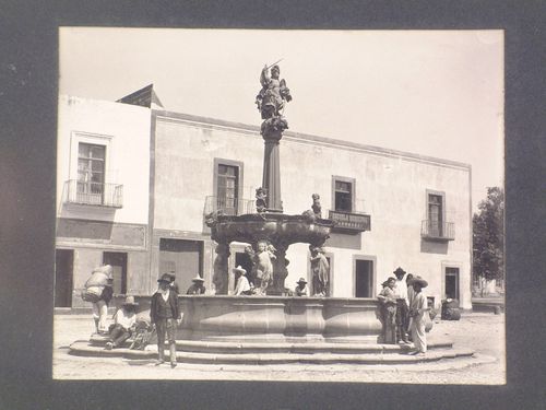 View of the San Miguel Fountain and people in the Plaza de la Constitución with buildings in the background, Puebla, Mexico