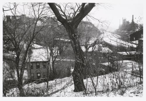 View on a hill overlooking houses, highway, and steel mill in snow, on right, Pittsburgh, Pennsylvania