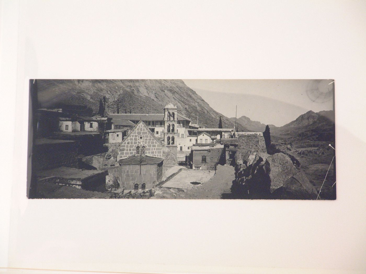 View of an unidentified village with mountains in the background