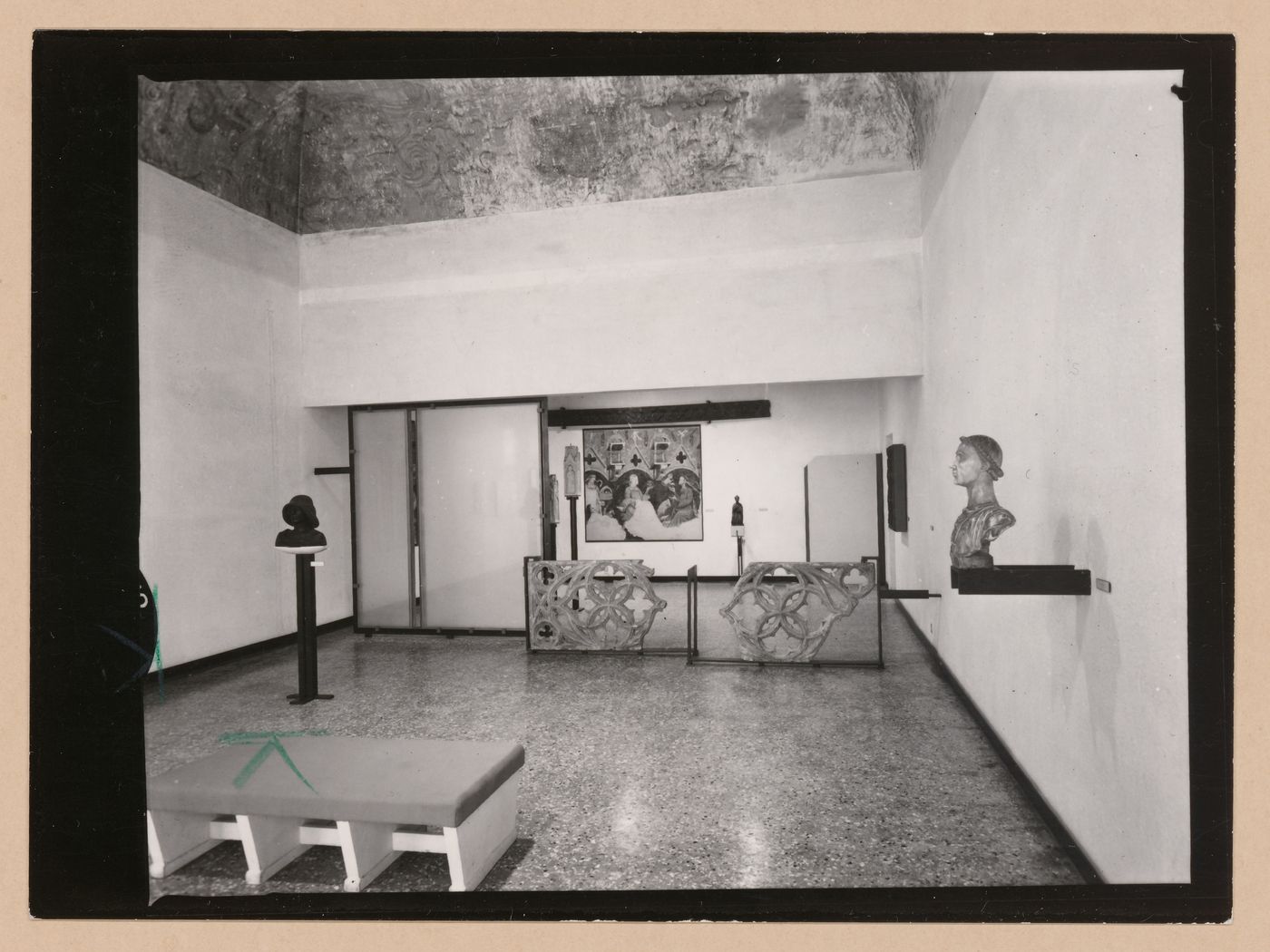 Interior view of a gallery showing a bench, fragments of stone tracery and a painting, Museo Correr, Venice, Italy