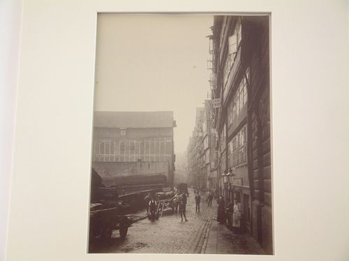 View of "Hinter den Boden" street with workers, residents, and wagons, Hamburg, Germany