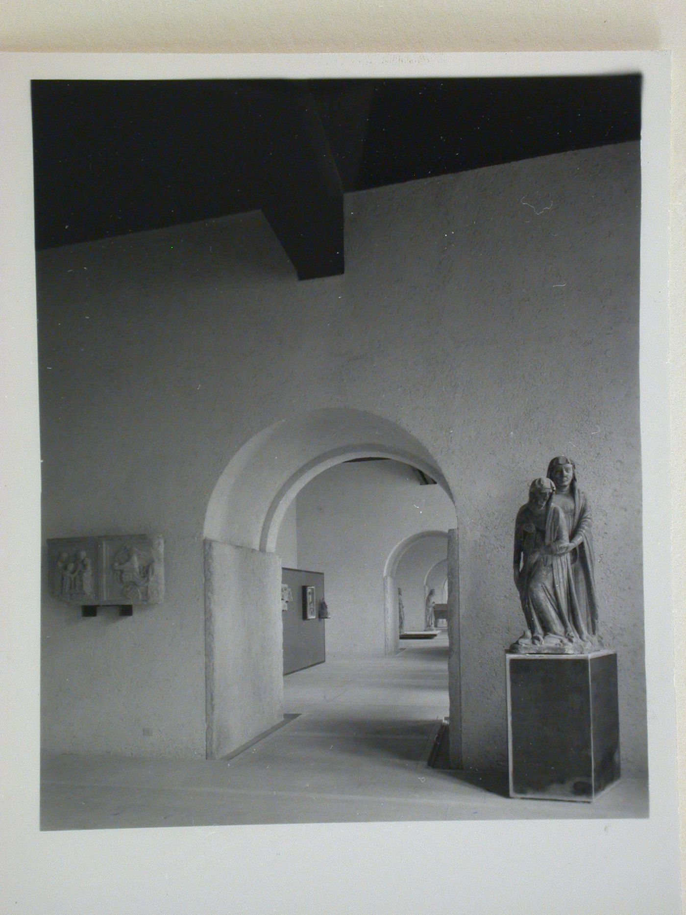 Interior view of a gallery showing doorways, a statue and reliefs, Museo di Castelvecchio, Verona, Italy