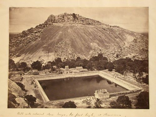 View of Vindhyagiri with the Odegal Basti, Brahmadeva Mandapa, Channanna Basti, Siddhara Basti and Gommateshvara Image on the summit and a water tank and buildings at the base, Shravana Belgola (now Sravana Belgola), India