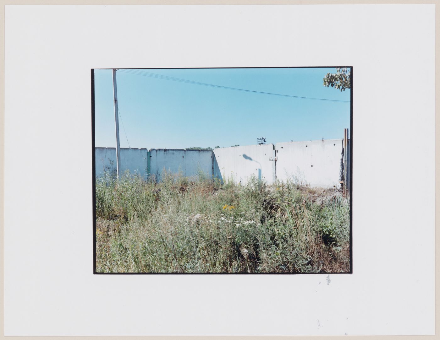 View of concrete walls and a vacant lot, Ushakovo, near Ladushkin, Kaliningradskaia oblast', Russia (from the series "In between cities")