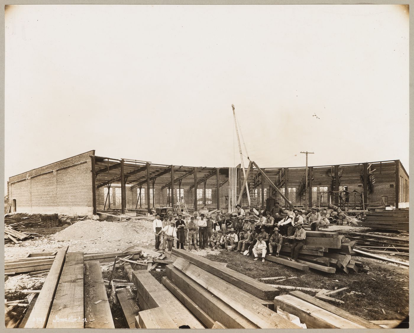 Group portrait of workers in front of the Canadian Pacific Railroad Company Roundhouse under construction, Coquitlam (now Port Coquitlam), British Columbia