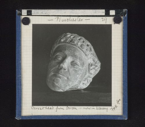 View of sculpture of head in library, sculpture originally from screen, Winchester Cathedral, Winchester, Hampshire, England