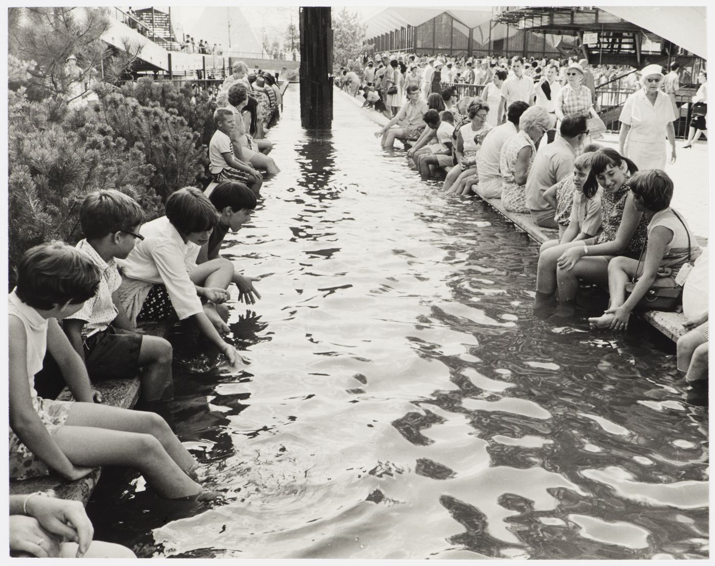 Visitors soaking their legs in water, Expo 67, Montréal, Québec