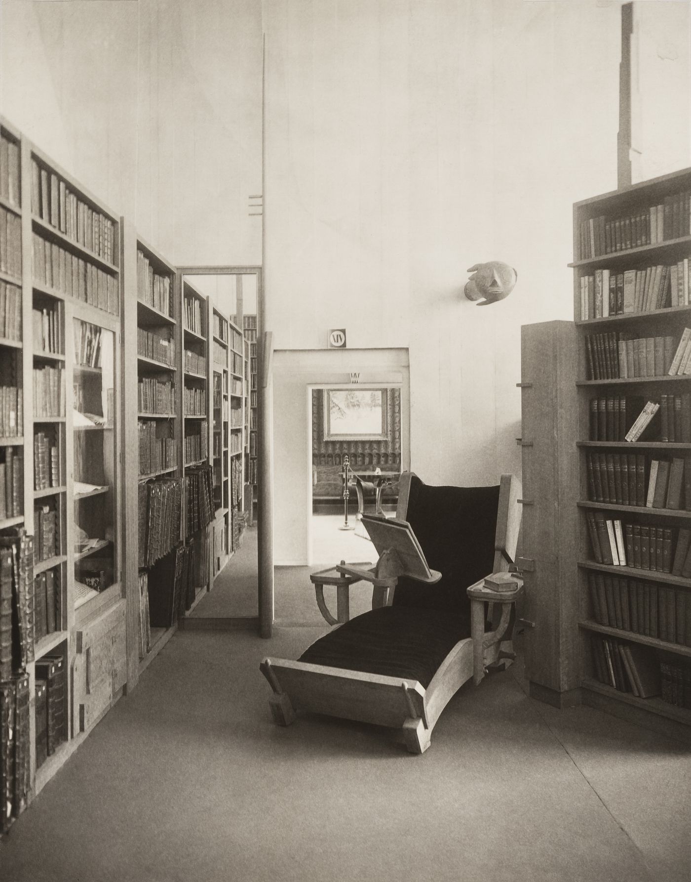 Interior view of library, with chaise lounge equipped with reading stand
