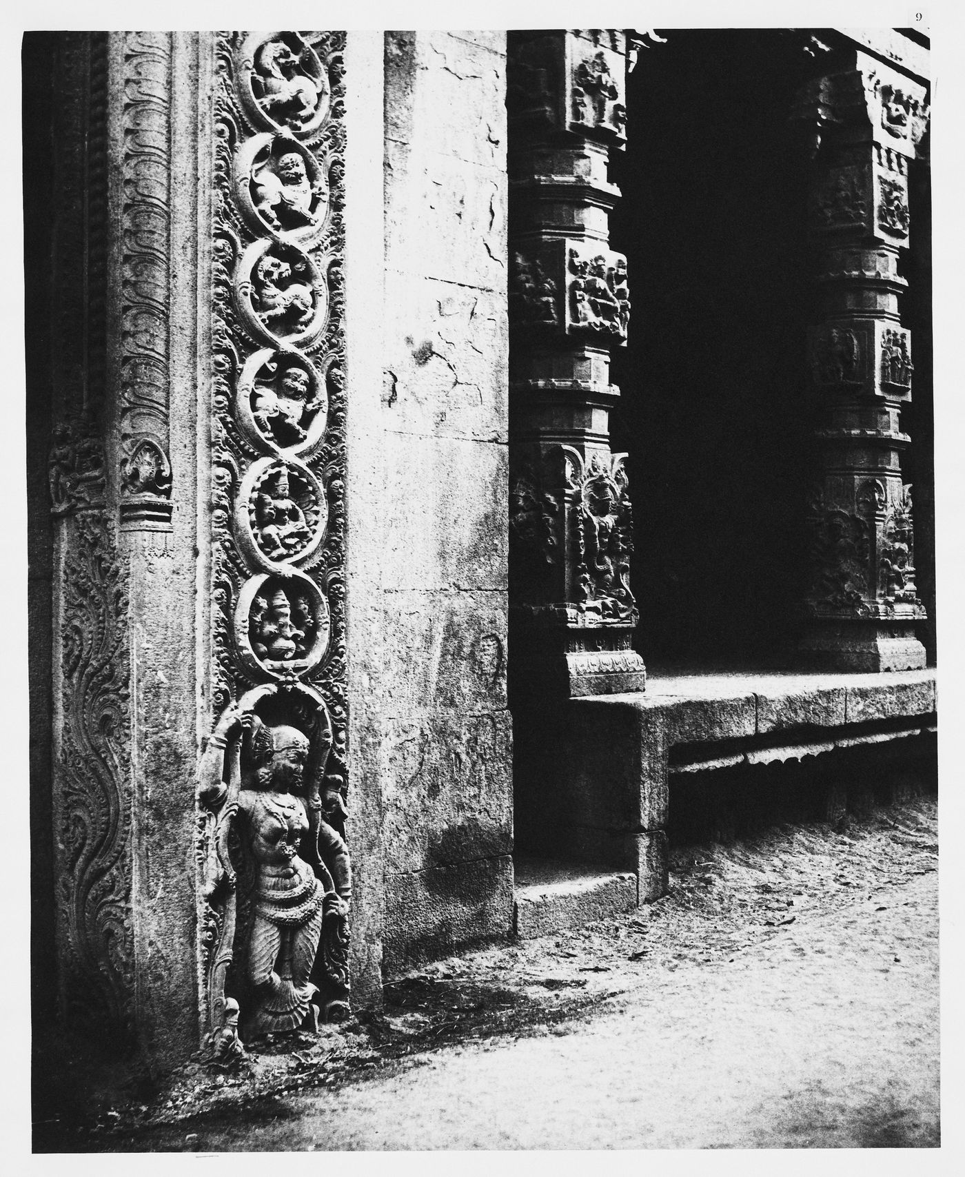 Madura.  Pillars in the recessed portico in the roya gopurum with the base of one of the four sculptured monoliths.