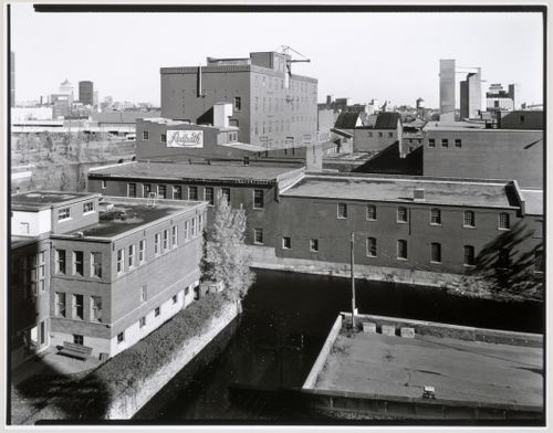 View of the Redpath Sugar Refinery looking east from the roof of the Belding Corticelli Spinning Mill with Lachine Canal and downtown Montréal in the background, Montréal, Québec