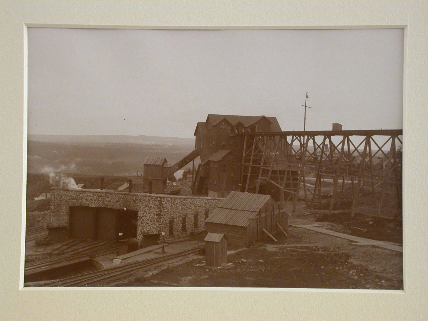 View of track, brick car housing, wooden mine shafts and scaffolding