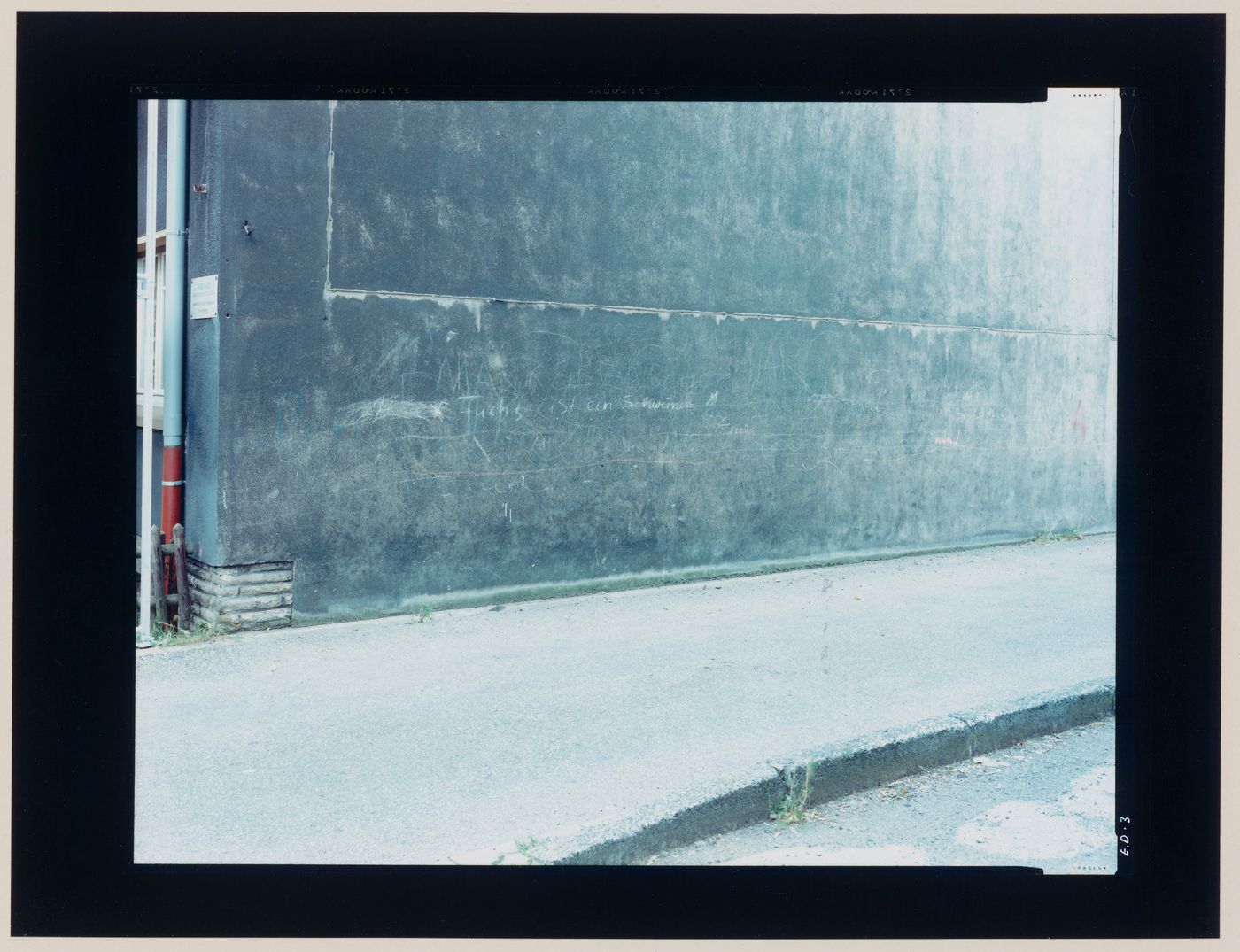 View of a wall with graffiti and a sidewalk, Essen, Germany (from the series "In between cities")