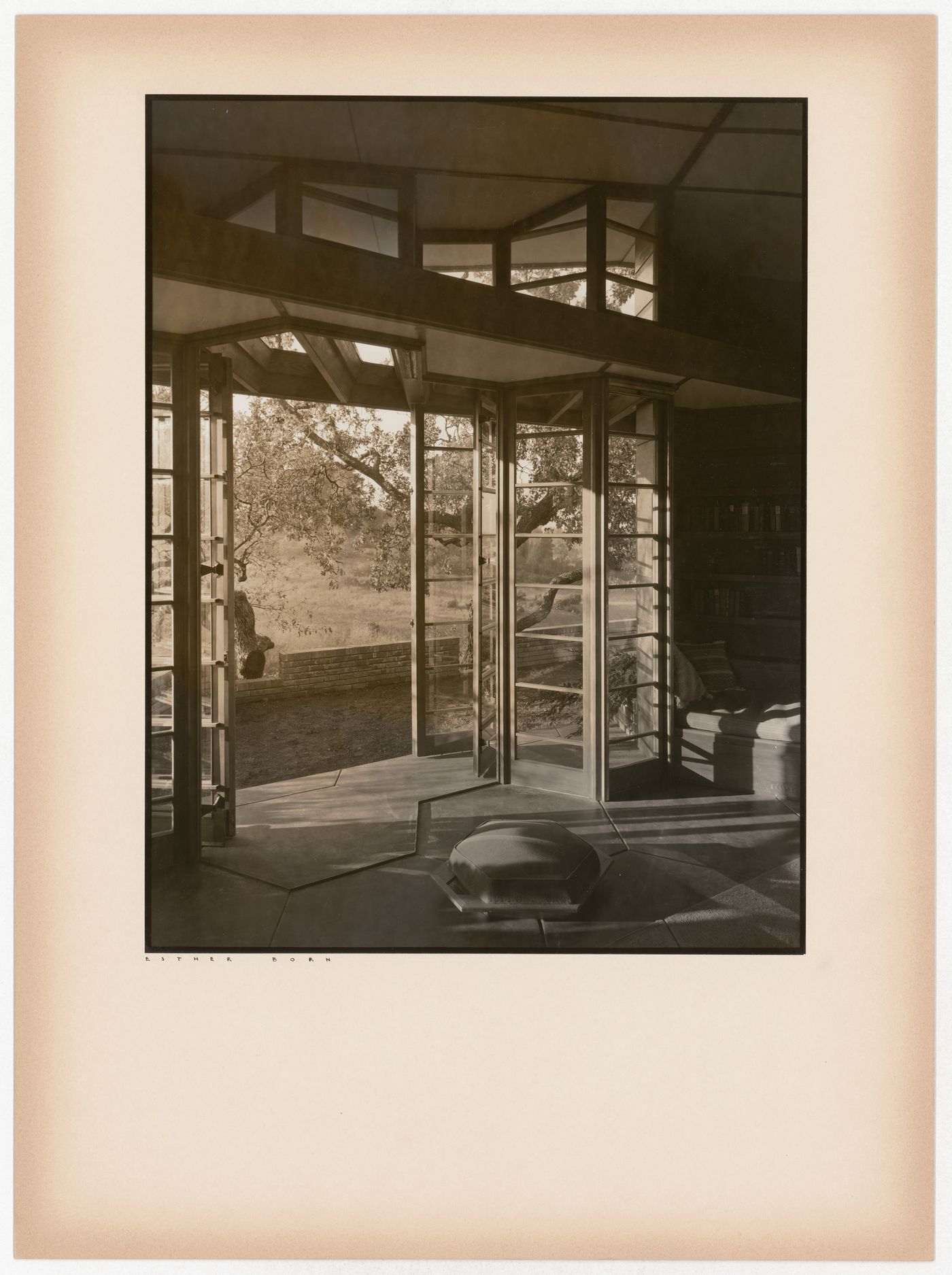 Interior view of the Hanna House showing an open doorway, windows, and seating furniture, Palo Alto, California, United States