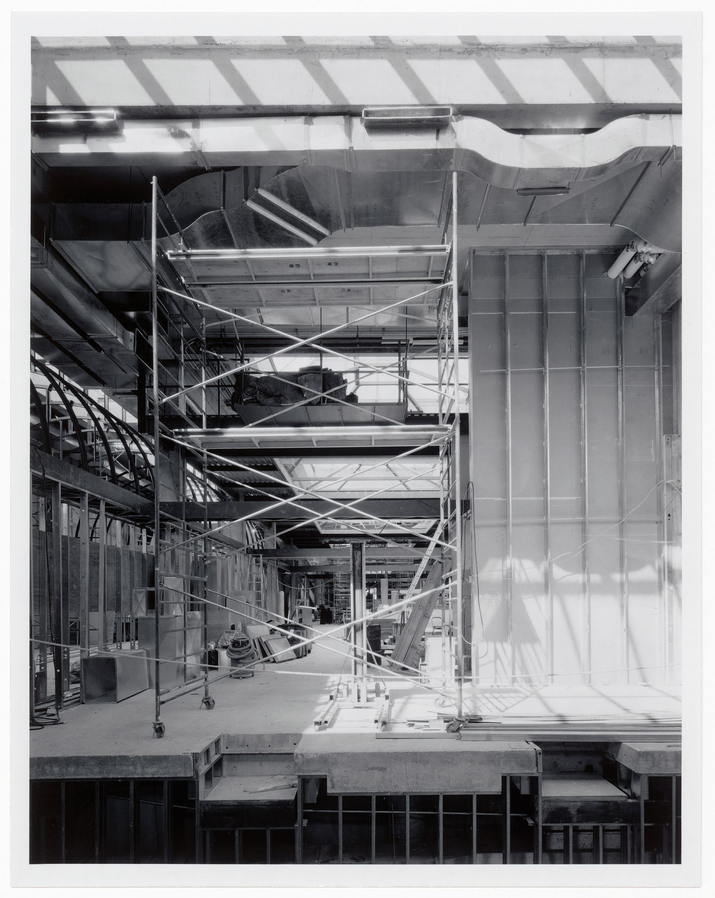 Interior view of the exhibition galleries from across the Entrance Court showing scaffolds and air ducts, Canadian Centre for Architecture under construction, Montréal, Québec