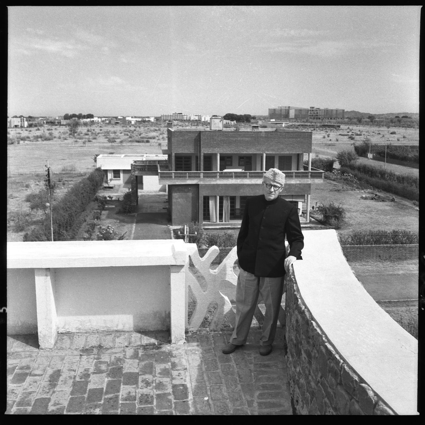 Portrait of Pierre Jeanneret with an unidentified building and the Secretariat in background, Chandigarh, India