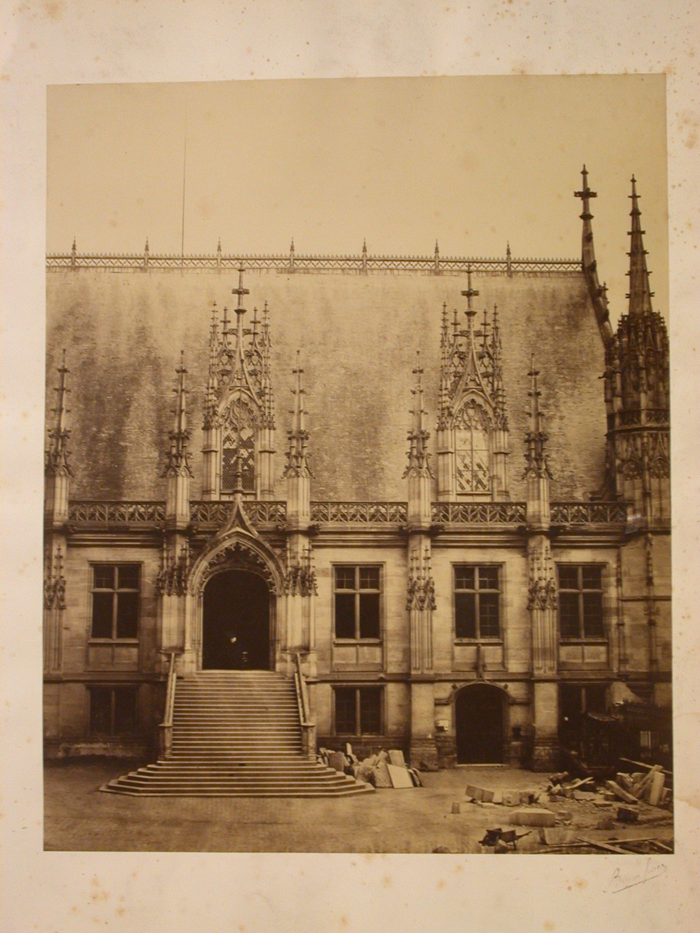 Exterior view, probably detail of side and entrance of Palais de Justice, during restoration, Rouen [?], France