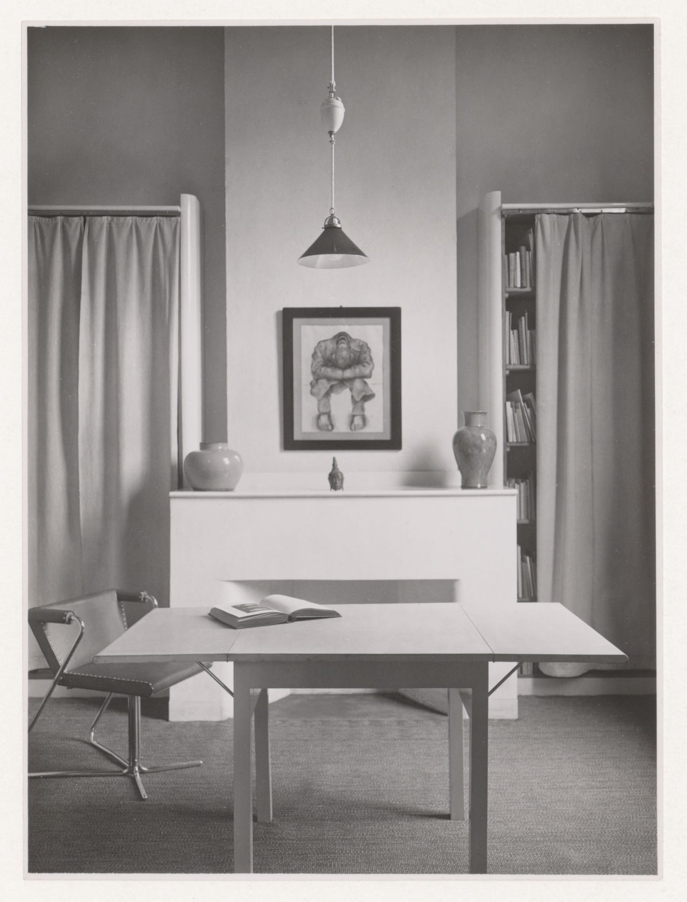 Interior view of the study of Hannema House I showing an elbow chair designed by J.J.P. Oud, a dropleaf table and curtained bookshelves, Rotterdam, Netherlands