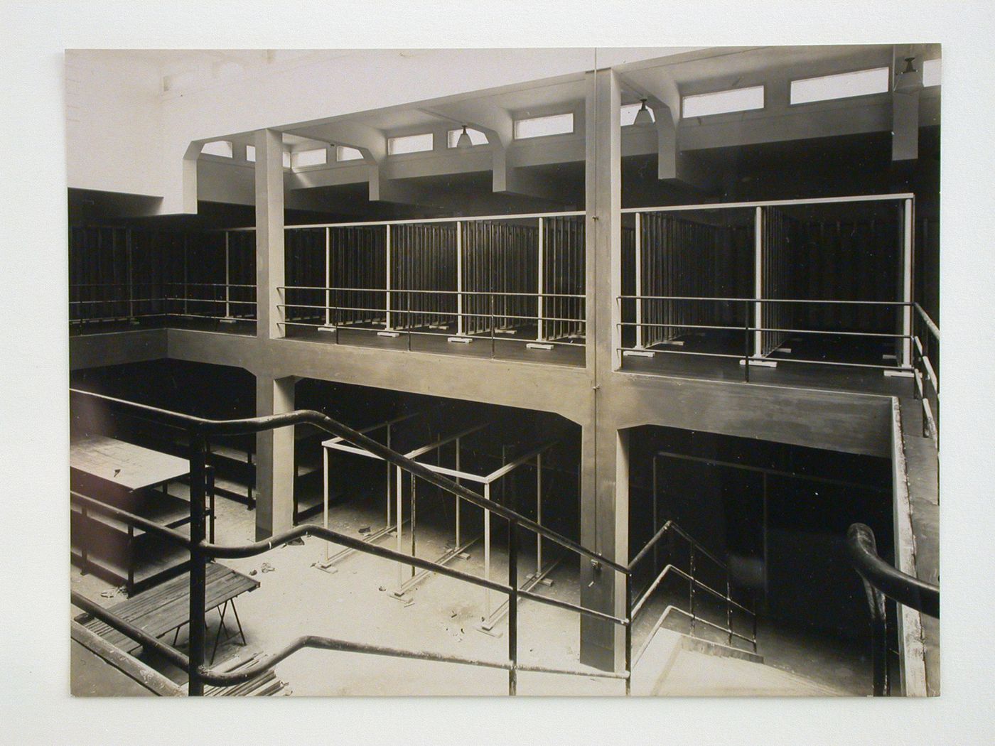 Interior view of inspections agency for electrical works, showing open two-storey space with stairs in foreground, Frankfurt am Main, Germany